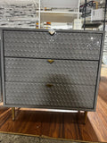 Metal dresser with gold handles.