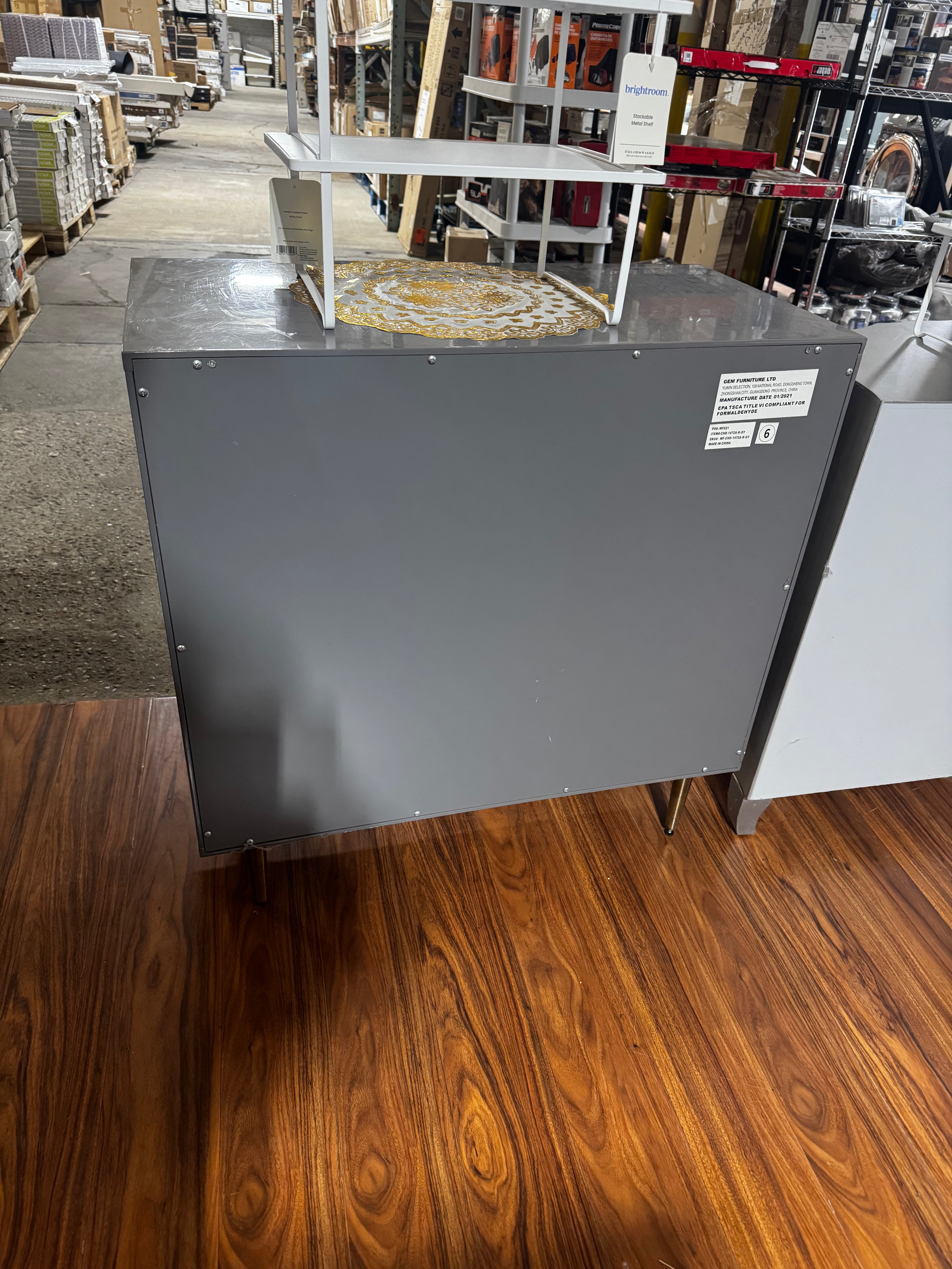 Metal dresser with gold handles.